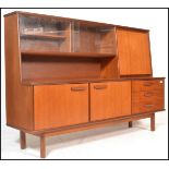 A retro 20th Century teak wood highboard sideboard credenza, being raised on square supports