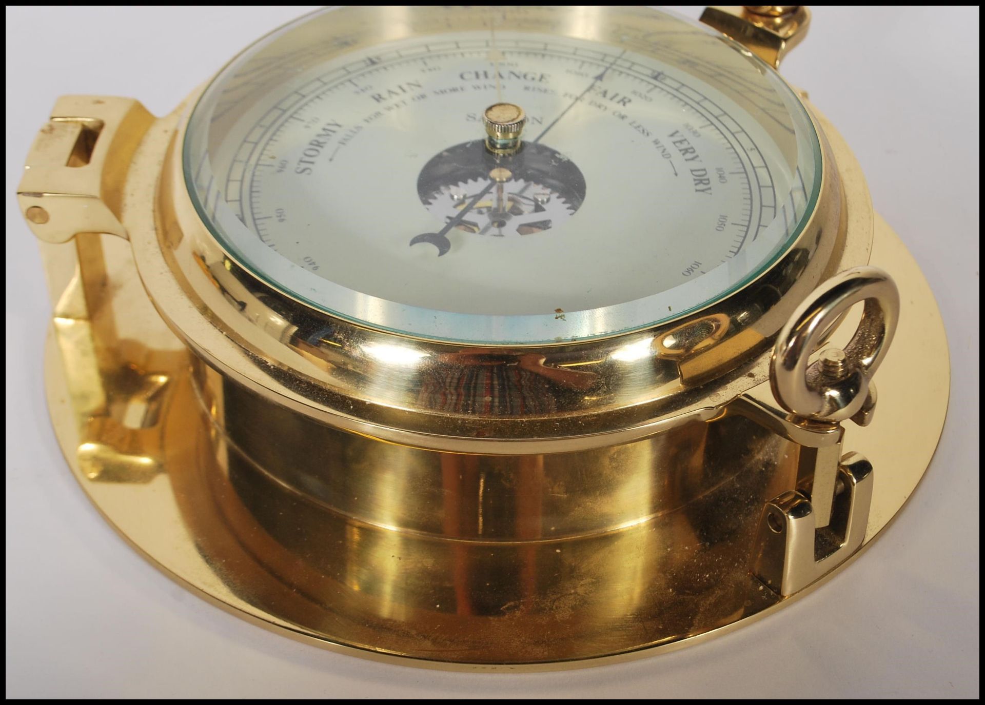 A contemporary 20th Century brass cased wall mounted ships barometer in the form of a porthole. - Image 2 of 5