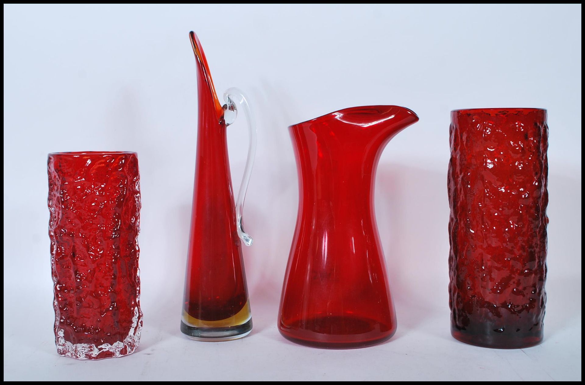 A group of four mid 20th Century vintage retro studio ruby red glass vases to include two bark