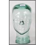 A vintage 20th Century point of sale advertising Milliners display pressed glass phrenology head.