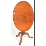 A 19th Century mahogany tilt top tripod wine table, with circular top raised on a turned baluster