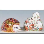 Two Crown Derby paperweights having gold stoppers to include a hedgehog and a rabbit, each having