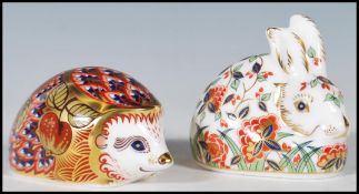 Two Crown Derby paperweights having gold stoppers to include a hedgehog and a rabbit, each having