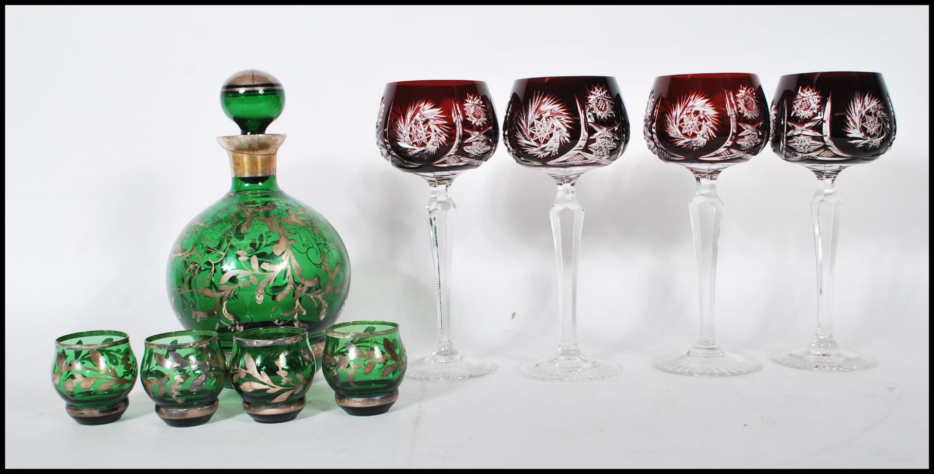 A believed 19th century Loetz manner silver overlay green glass Bohemian decanter and shot glass set