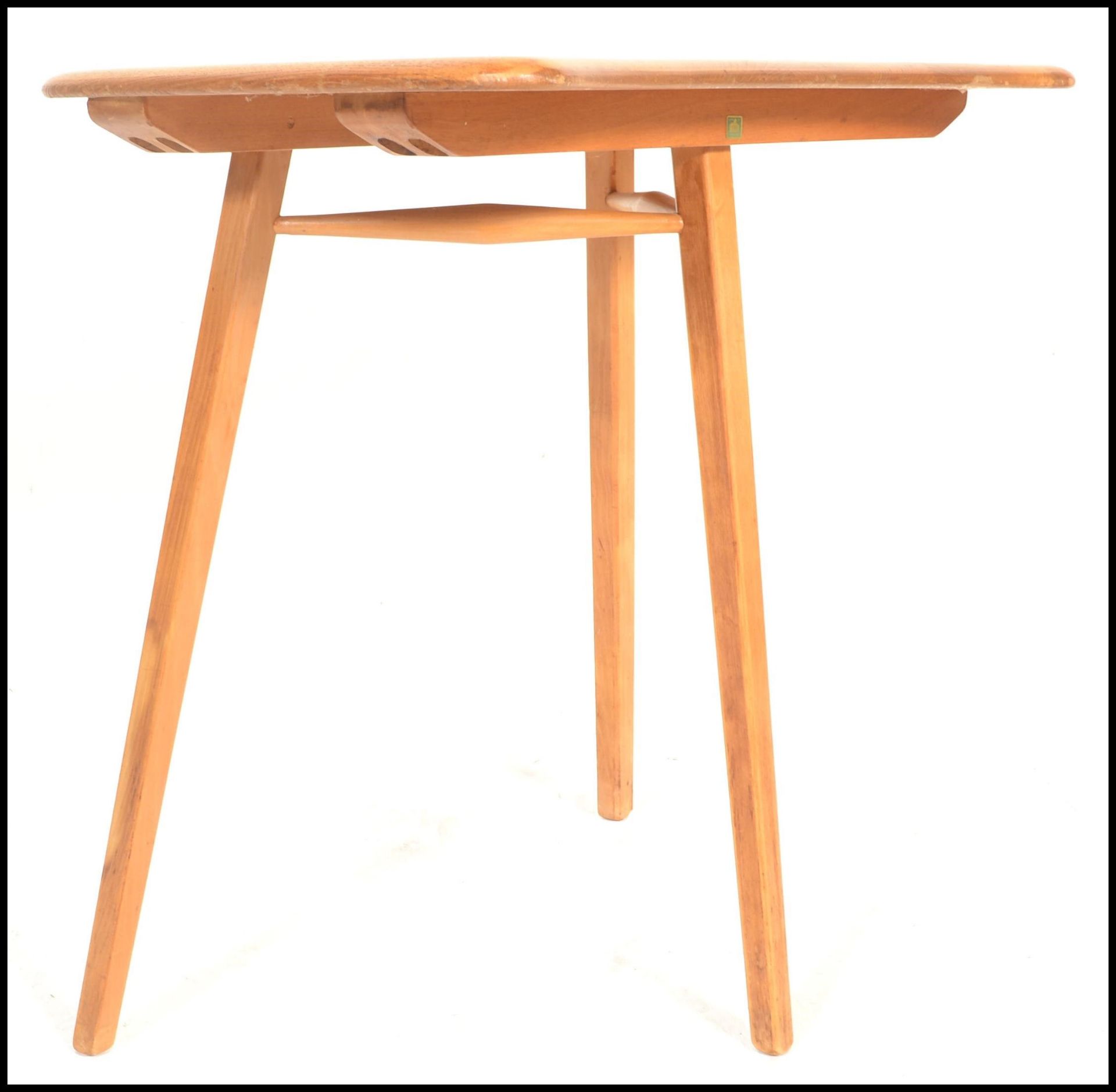 Ercol- A retro mid 20th Century beech and elm blonde Ercol table extension raised on tapering