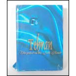 A large book entitled Tehran The Jewel on The silk Road published by Taher Inc. Art in