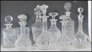 A selection of 20th Century cut glass crystal decanters of various forms all having they're original