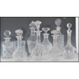 A selection of 20th Century cut glass crystal decanters of various forms all having they're original