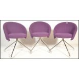 A set of three contemporary office chairs by Lyreco, the tub style seat pads covered in purple
