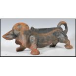 An early 20th Century cast iron boot scraper scrape in the form of a Dachshund dog. Measures 11 cm