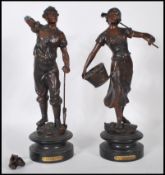 A pair of 19th Century high Victorian bronzed spelter figures modelled as a male and female farm