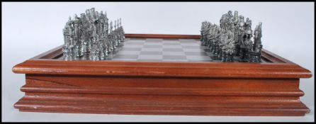 A Danbury Mint collectors pewter ' Camelot ' King Arthur / Excalibur chess set complete within the