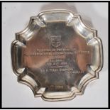 A silver hallmarked pin dish / ashtray being marked ' Reception of Members of the International