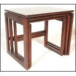 A 1970's retro vintage mahogany graduating nest of tables in the quadrille pattern. The tables