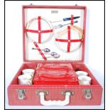 A mid century retro, circa 1950's Brexton style picnic hamper set within its original red vinyl