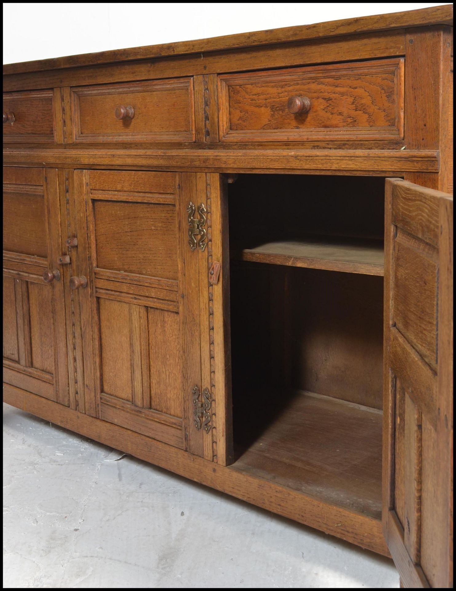 A 20th Century oak Jacobean revival sideboard credenza, flared top over a configuration of drawers - Image 5 of 6