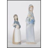 Lladro - A pair of 20th Century porcelain ceramic figurines comprising: 4650 Girl with Calla