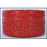A 20th Century Chinese Cinnabar round desk top box of round form having carved relief of a Chinese