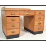 A 1930's Art Deco oak twin pedestal office desk. Raised on ebonised plinths with banks of drawers to