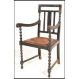 A good 19th Century carved ebonised oak bobbin open framed armchair / desk chair, carved open