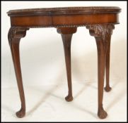 An early 20th Century Art Deco demi-lune card console table having a shaped walnut veneered