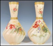 A pair of  Royal Worcester blush ivory vases, with conical necks and wrythen body, decorated with