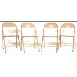 A set of 4 mid 20th century  tubular metal industrial folding / stacking chairs. Each with painted
