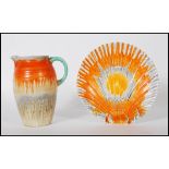 A 1930's Art Deco Shelley ceramic side plate in the form of a scallop shell having an orange and