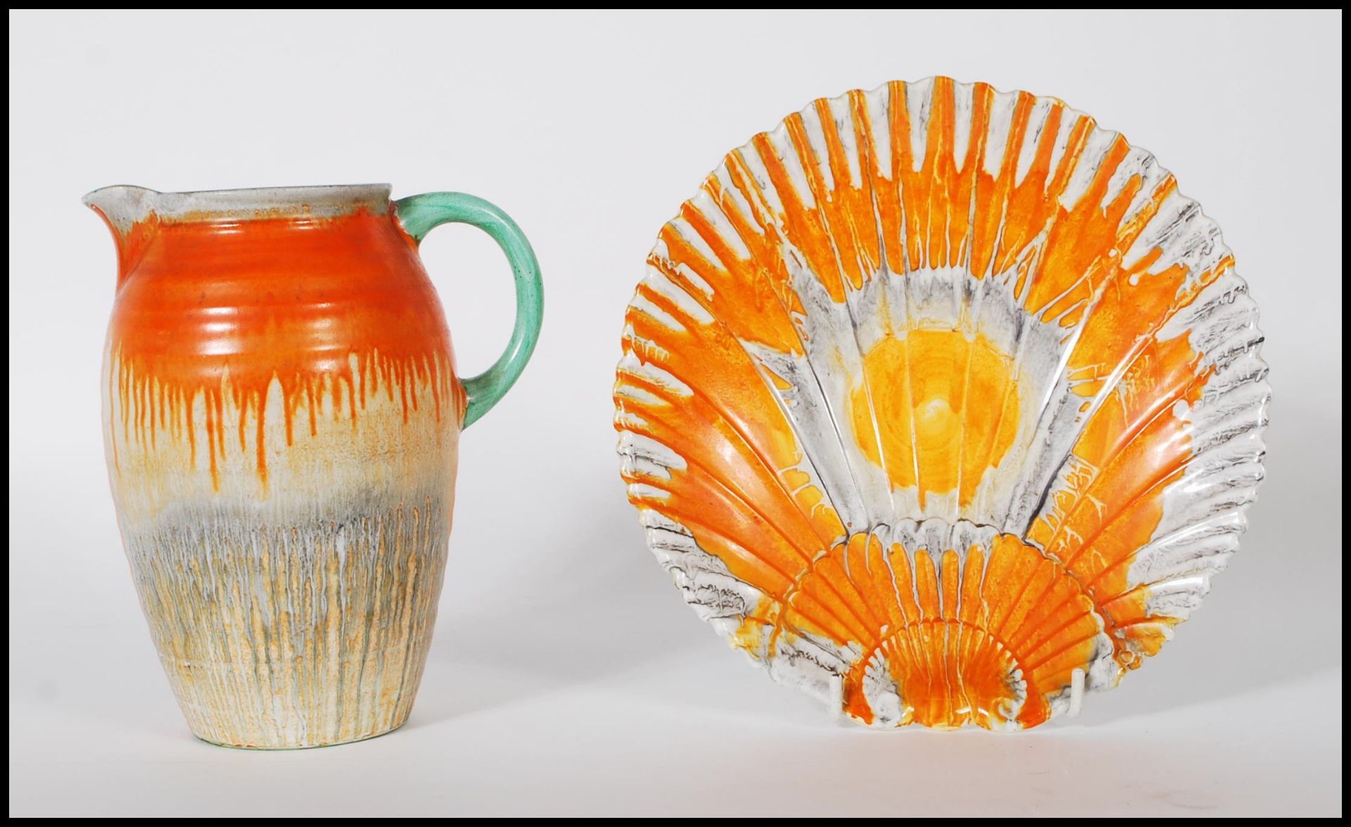 A 1930's Art Deco Shelley ceramic side plate in the form of a scallop shell having an orange and