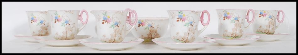 An early 20th Century Shelley coffee service having pink and blue floral sprays with butterflies and