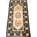 A large early to mid 20th Century woollen floor rug carpet, large central panel of poly-chrome