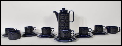 A vintage Hornsea pottery coffee service in the Heirloom pattern having a navy blue glaze with black