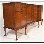 A 20th Century walnut inverted breakfront sideboard credenza having a configuration of drawers and