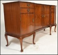 A 20th Century walnut inverted breakfront sideboard credenza having a configuration of drawers and