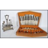 A 19th Century silver plate and cut glass cruet set, the fret pierced gallery surround having an