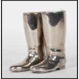A pair of silver plated drinks / spirit measures in the form of riding boots, having white