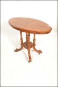A Victorian 19th century walnut and mahogany oval tilt top loo / breakfast table.  Raised on a
