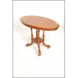 A Victorian 19th century walnut and mahogany oval tilt top loo / breakfast table.  Raised on a