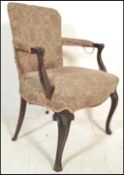 A 19th century French empire mahogany fauteuil armchair being raised on cabriole legs with a