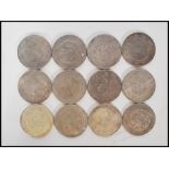 A collection of 12 20th Century Chinese coins marked kwang-tung province 7 mace and 2 candareens