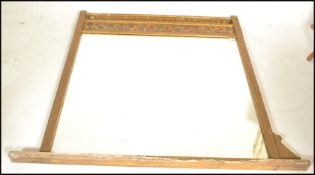 A large 19th Century Victorian Aesthetic movement overmantel wall mirror.  The gilt frame surmounted