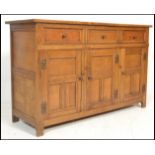 A 20th Century oak Jacobean revival sideboard credenza, flared top over a configuration of drawers