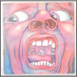 A vintage LP 12" vinyl record; King Crimson - In The Court of the Crimson King ILPS 9111 pink i,