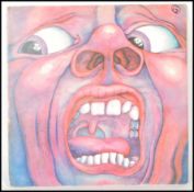 A vintage LP 12" vinyl record; King Crimson - In The Court of the Crimson King ILPS 9111 pink i,
