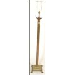 A 19th Century Victorian antique brass standard floor lamp having a stepped base with foliate