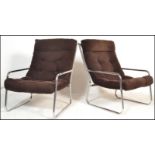 A pair of retro 20th Century cantilever chrome tubular framed lounge / easy open framed armchairs in