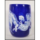 A 20th century studio art glass hand blown blue glass vase of cylindrical form having white swirl