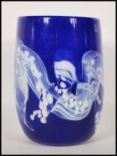 A 20th century studio art glass hand blown blue glass vase of cylindrical form having white swirl