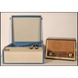 A retro mid century Tellux portable record player in a blue and white colourway together with a