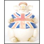 A contemporary large resin figure of a seated pig wearing a hat and Union Jack T-shirt with 'Best of